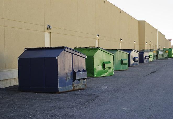 large garbage containers clustered on a construction lot in Chicopee